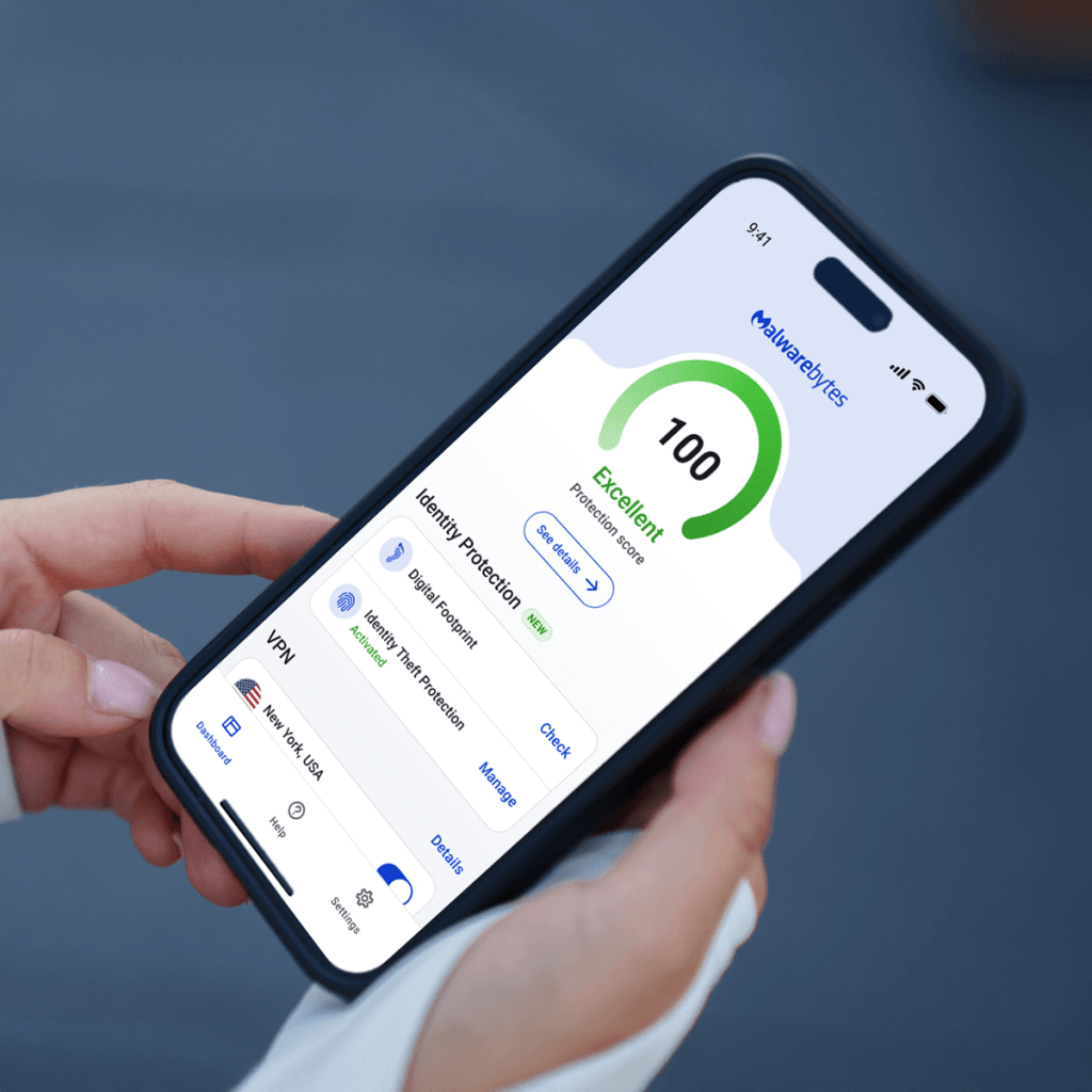 Photo of hands holding a mobile phone with the Malwarebytes for iPhone dashboard on the screen